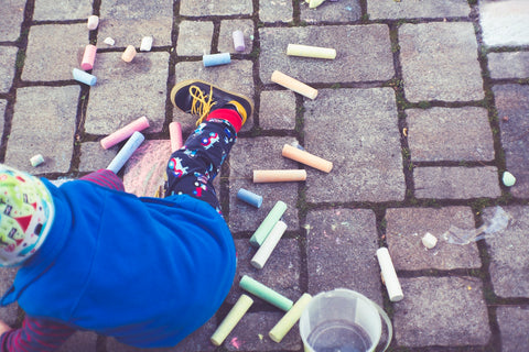kid playing with chalk