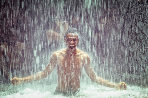 man under waterfall - cold shower