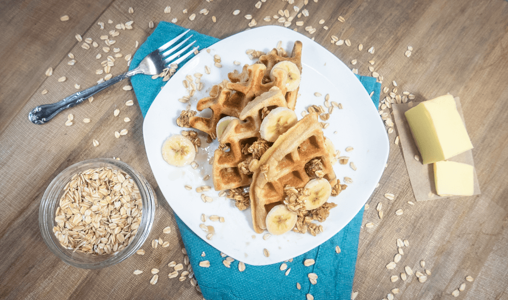 gluten free oat waffles topped with granola and bananas