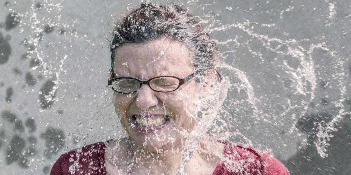 Water splashing in woman's face
