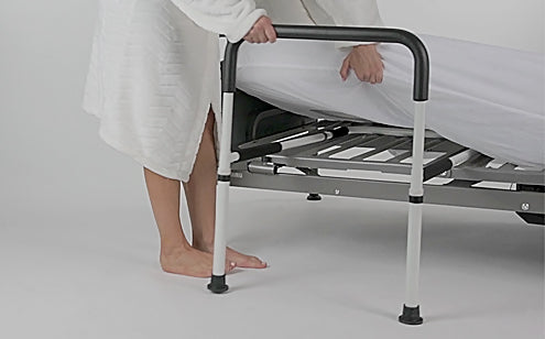 woman setting up bed rail on bed