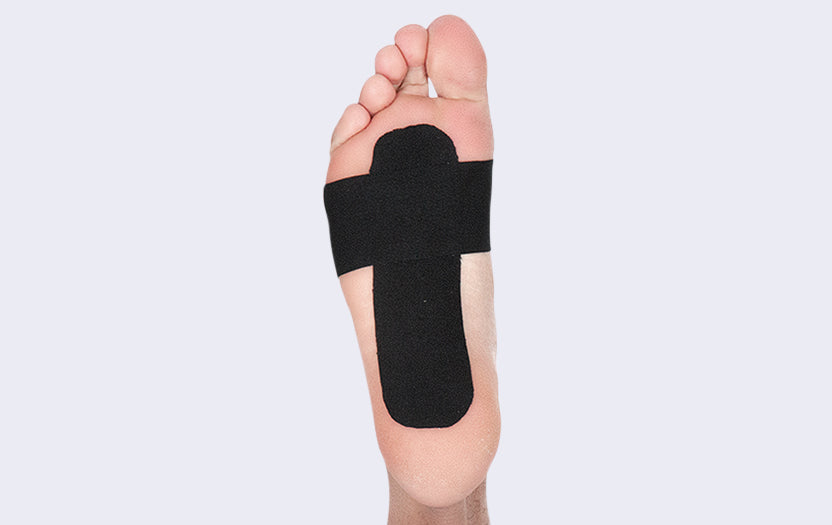 Foot with black tape on sole