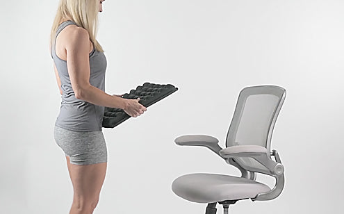 Middle age woman holding a max gel seat cushion