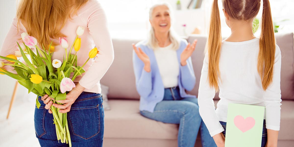 Two daughter with flower and gift card
