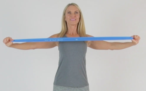 Middle age woman stretches loop resistance band