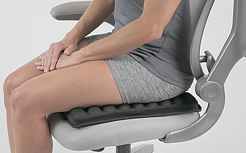 Woman sitting in a chair with max gel seat cushion