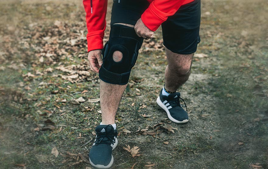 Man holding knee brace