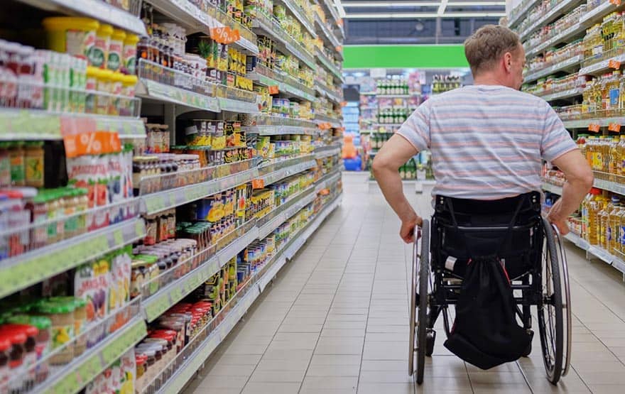 man shopping in wheelchair