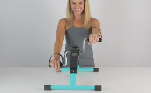 Middle age woman using pedal exerciser