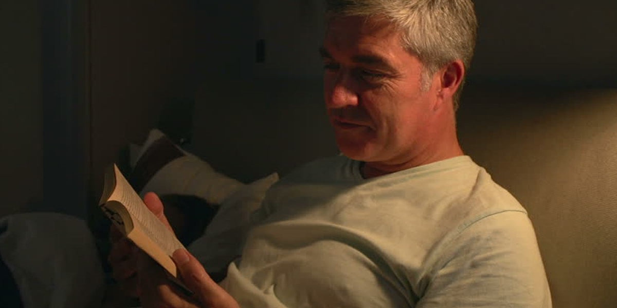 Old man reading a book before sleeping