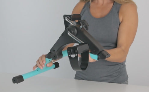 A woman folding the pedal exerciser