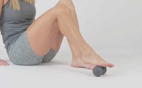 Massaging foot with peanut massage ball