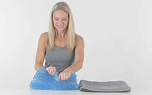 Middle age woman squeezing a gel seat cushion's Non liquid gel