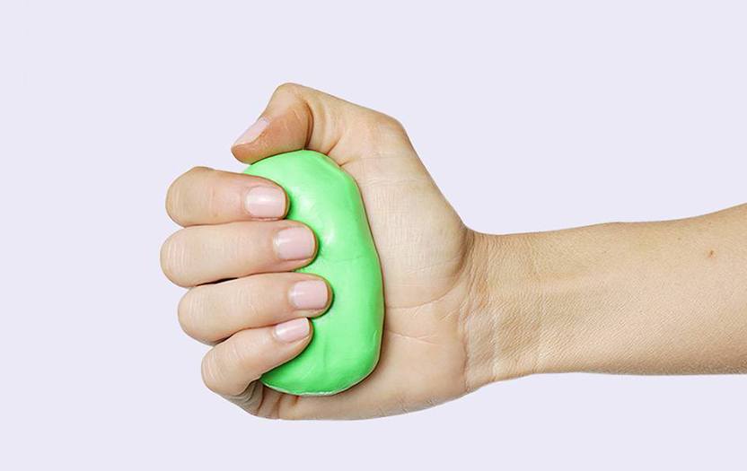 Right hand holding green thera putty