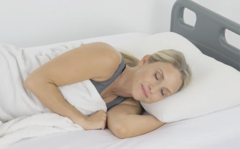 woman sleeping with white pillow and blanket