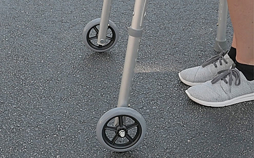 walker wheels rolling over concrete pavement