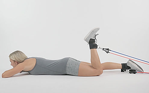 woman exercising legs with resistance bands
