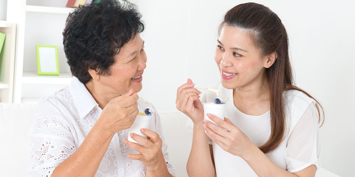 Young woman eating yogurt