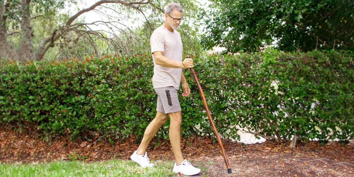 Senior walking with cane support