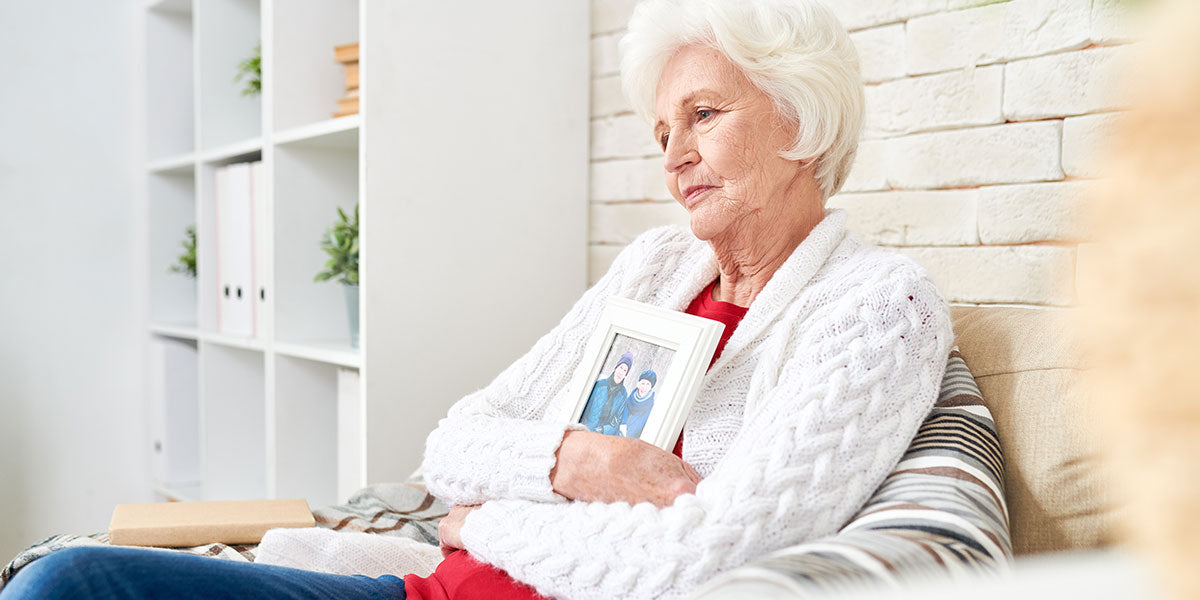 Senior woman sitting at home alone in armchair