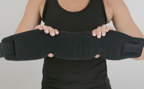 Woman holding a soft flexible foam neck brace