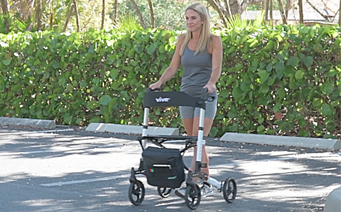 Middle age woman using a rollator with bag