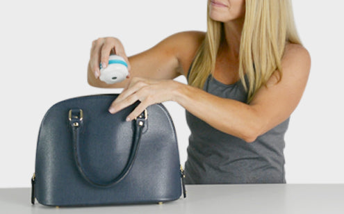 Woman holding a massage roller ball to put in the bag