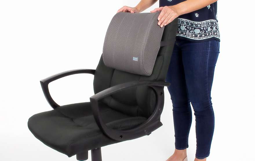 Woman holding a lumbar cushion on the chair