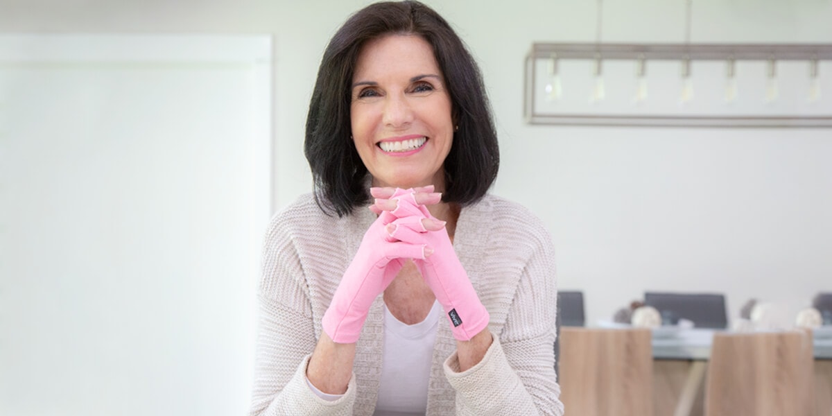 Woman wearing arthritis gloves