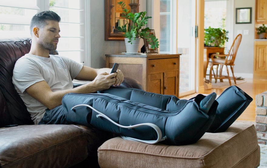 man using leg compression device
