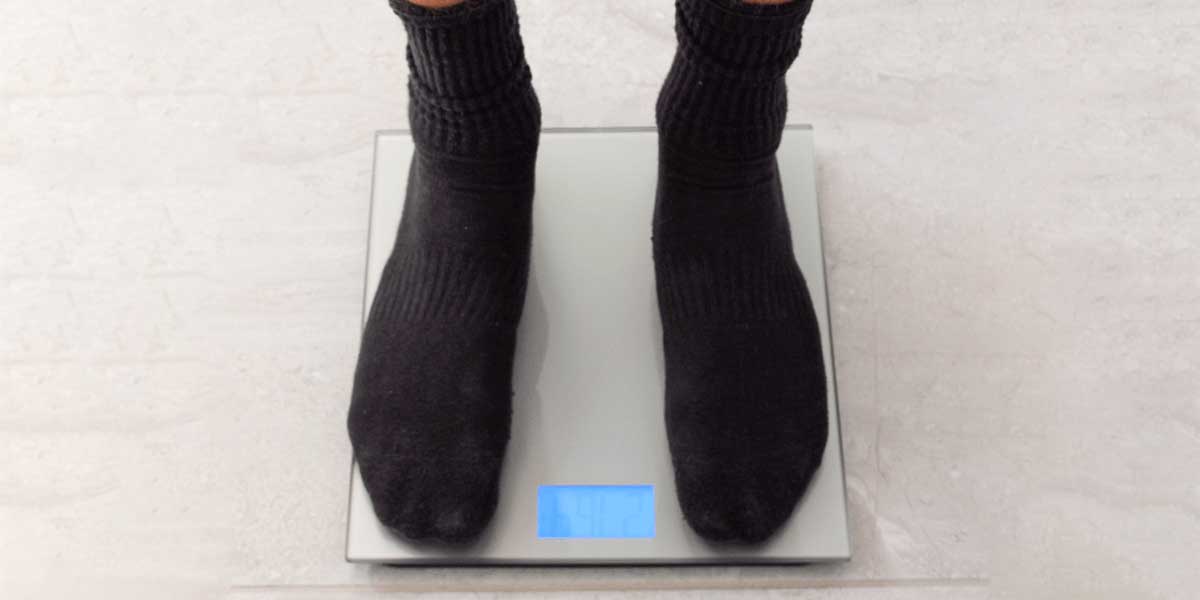 weighing self on digital scale