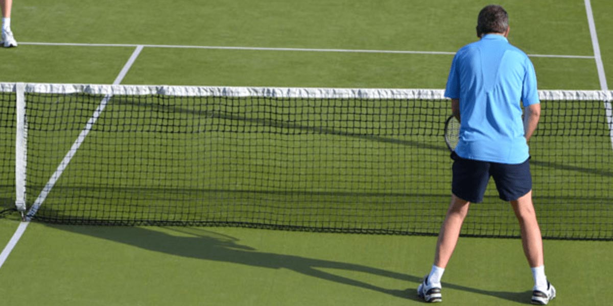 back of man playing tennis