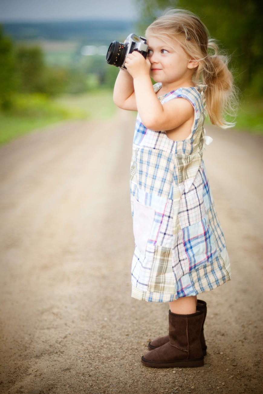  Cute toddler using camera during trip