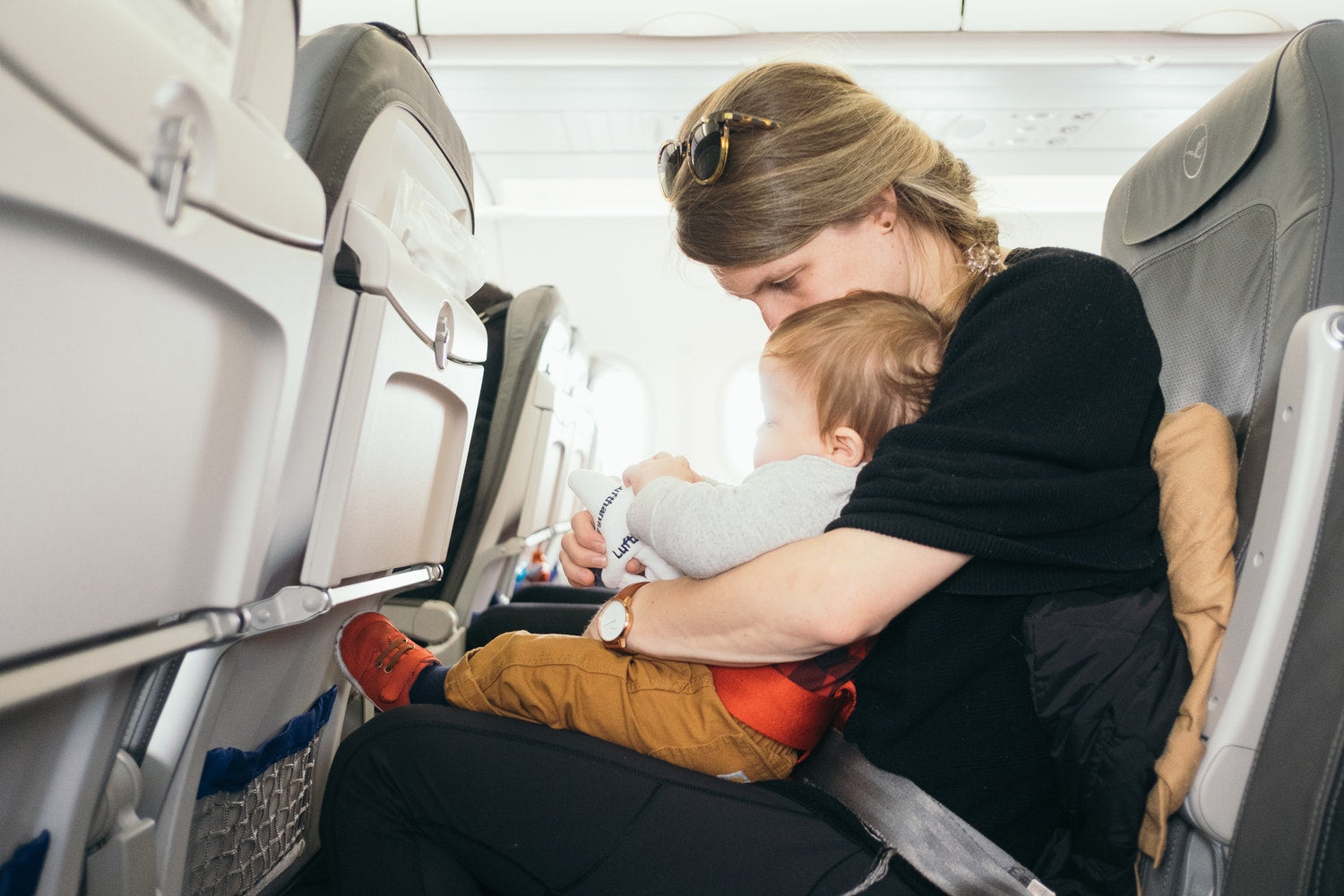 Mommy flying with baby on lap