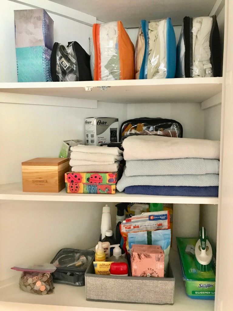 Linen closet organized with packing cubes