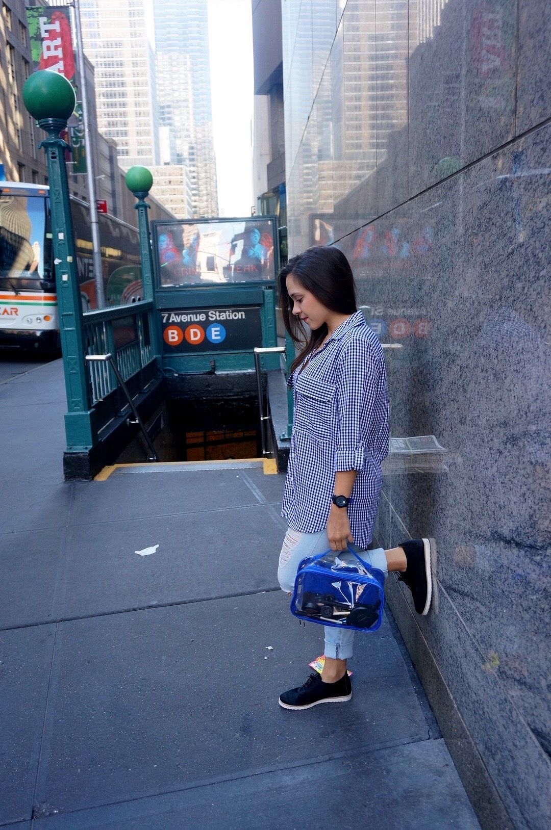 Young woman carrying a royal blue small packing cube