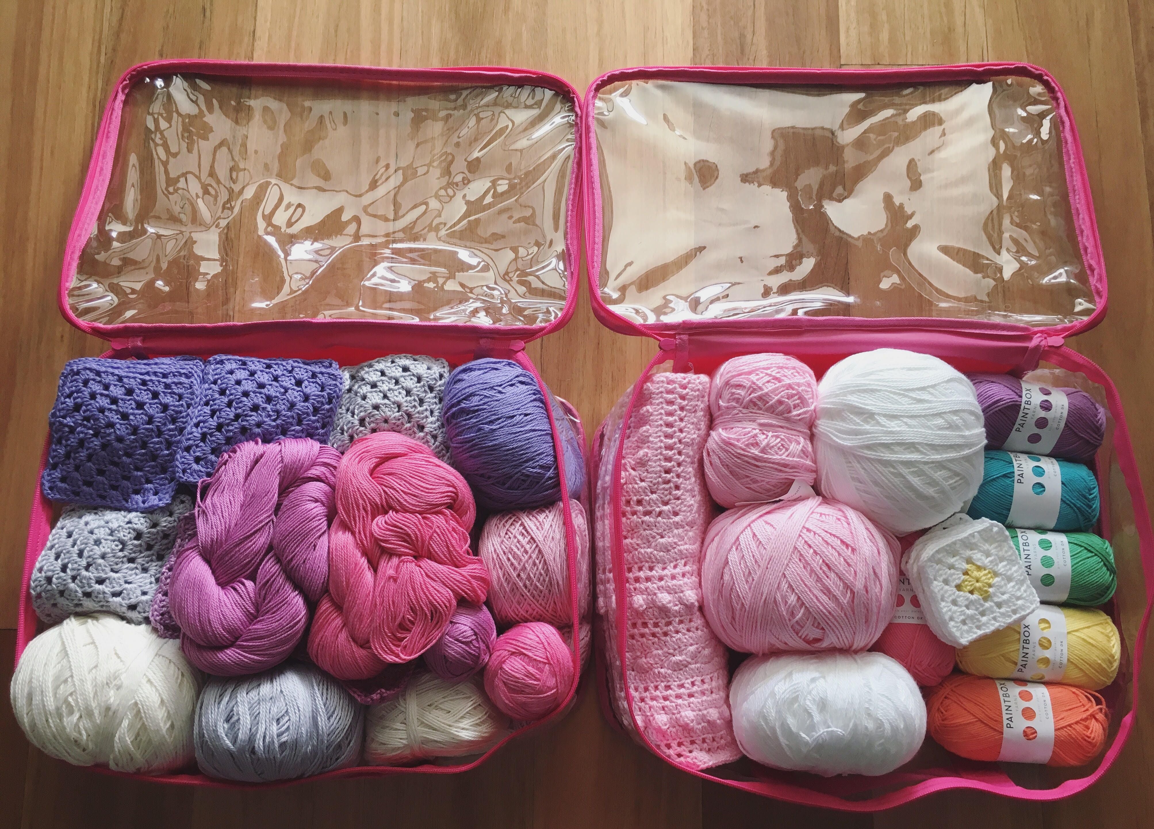 Organized colorful yarns in pink medium packing cubes