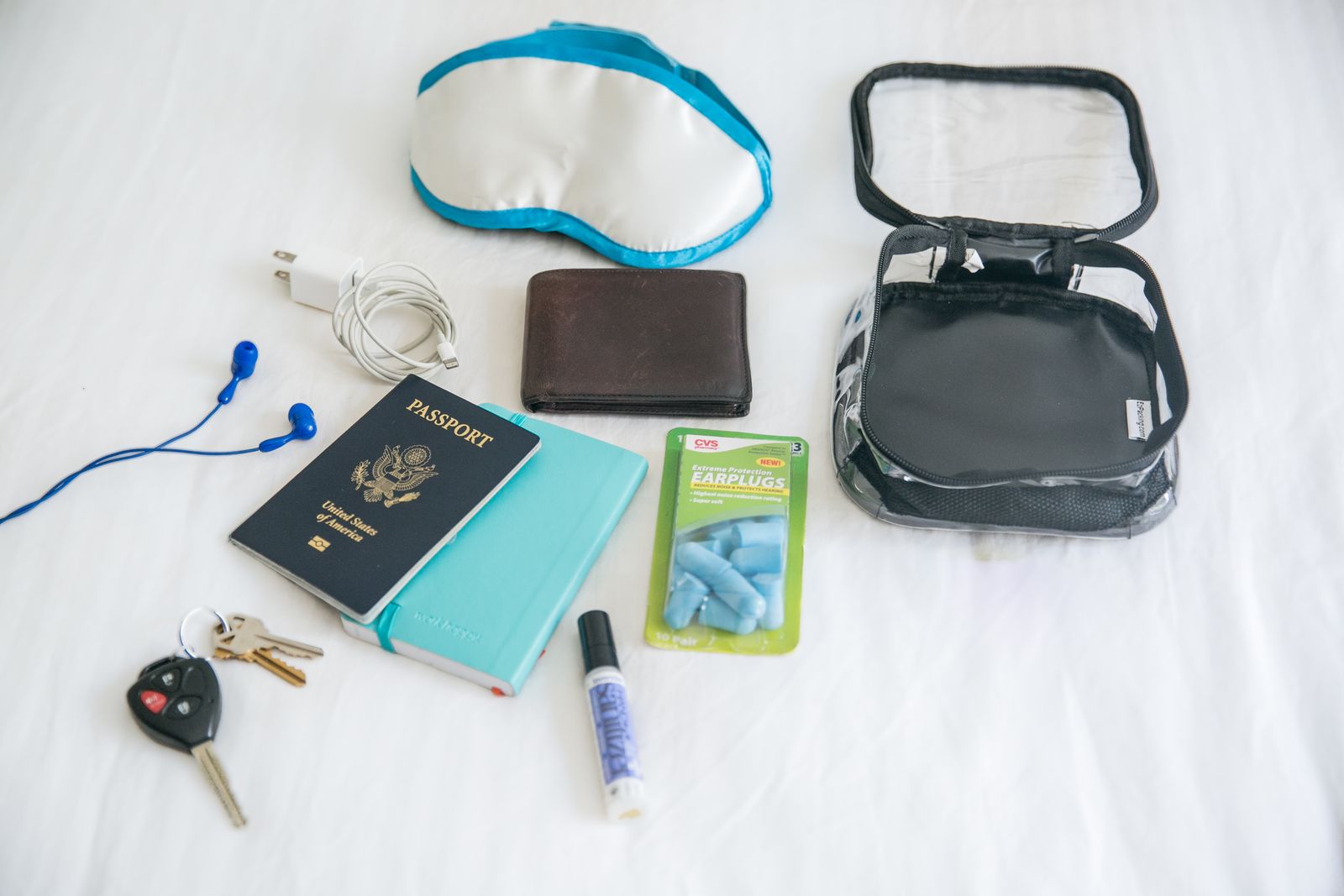 Passport and other essentials in a black extra small cube