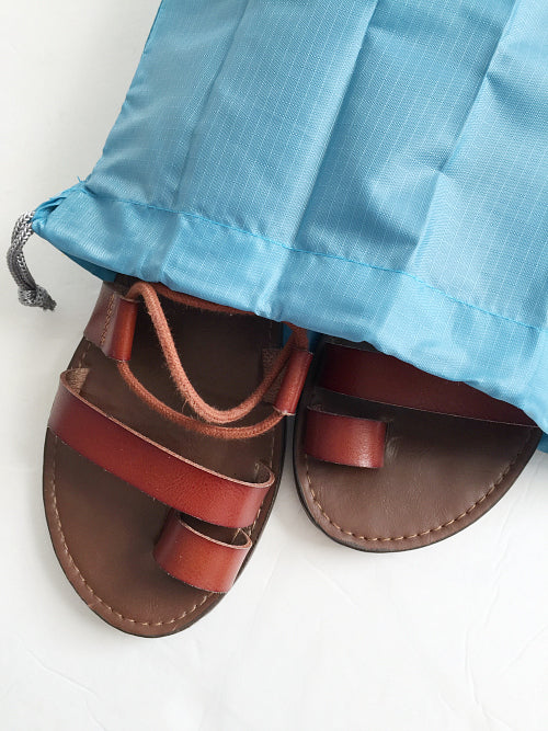 Sandals in a travel shoe bag for camping trip