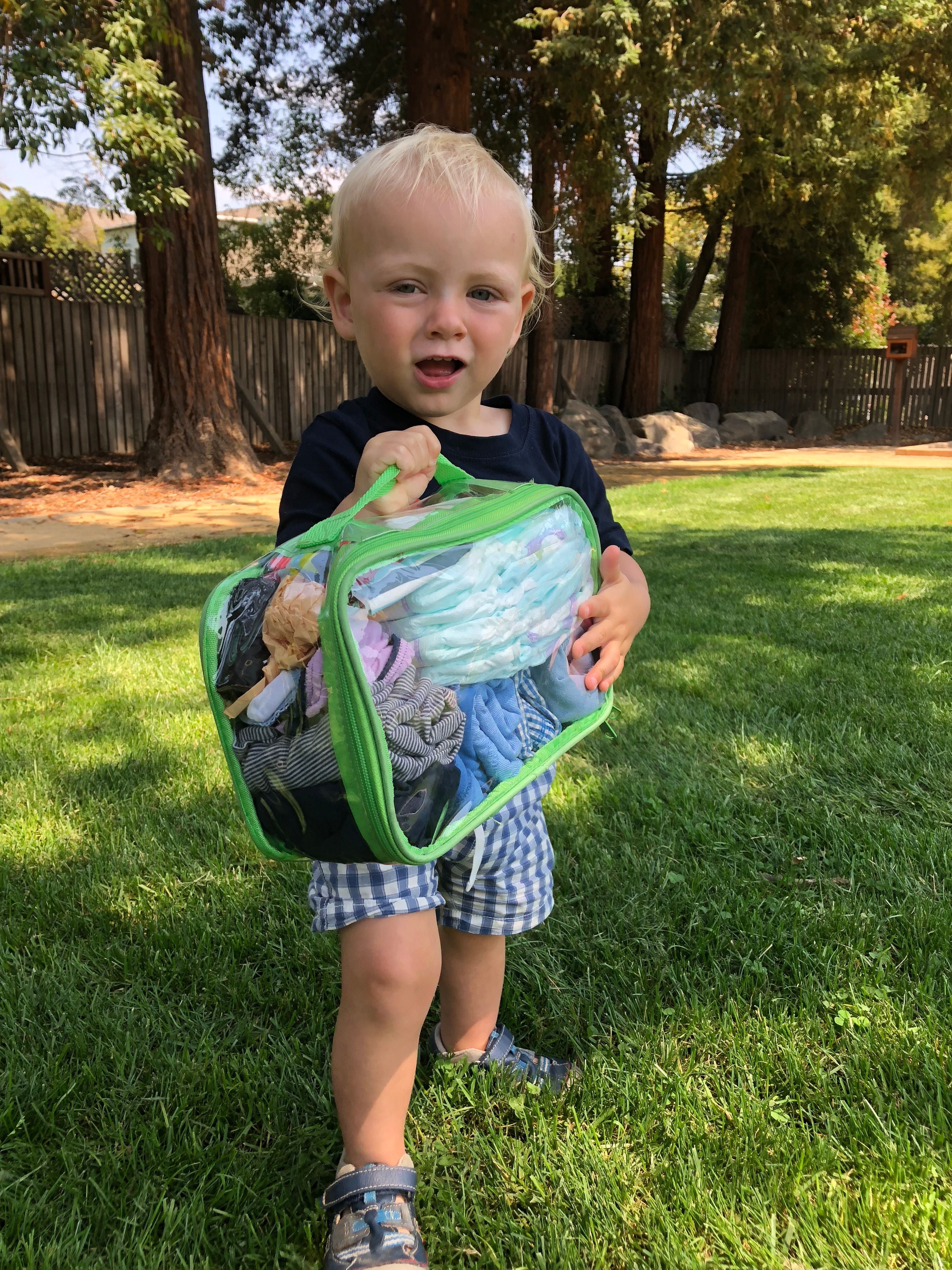 Toddler with a small green cube