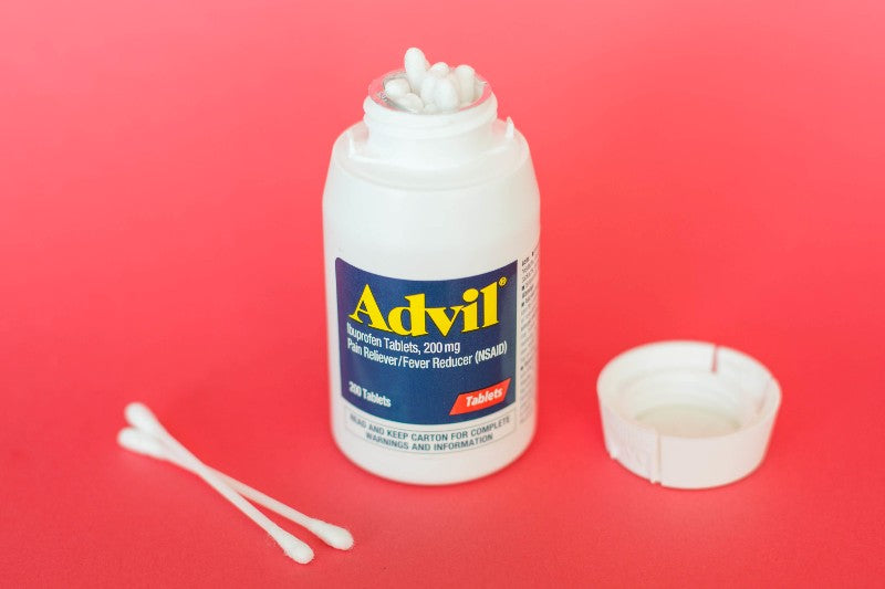 Use old medicine container for cotton swabs