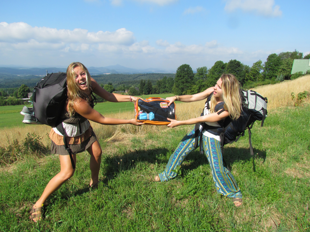 Girls fighting over packing cube with complete hiking necessities