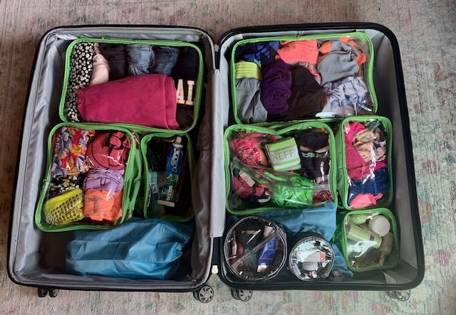 organized luggage using clear cubes