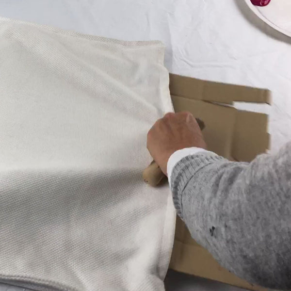 Insert the card inside the cushion cover before you begin stencilling.