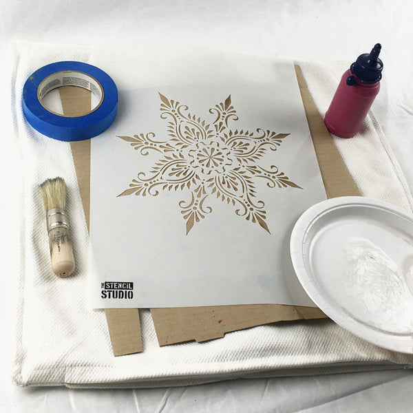Collect the things you need to start stencilling a cushion cover with fabric paints and stencils from The Stencil Studio