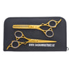hair cutting and thinning scissor lying on leather pouch