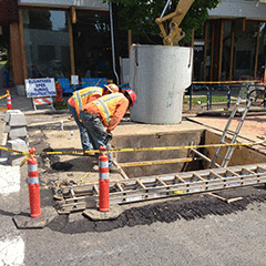 Construction Workers Installing A Sewer Line