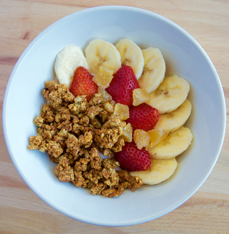 Bowl of fruit and granola with strawberries, bananas, and dried pineapple. Makes a great healthy  breakfast when you're short on time. 
