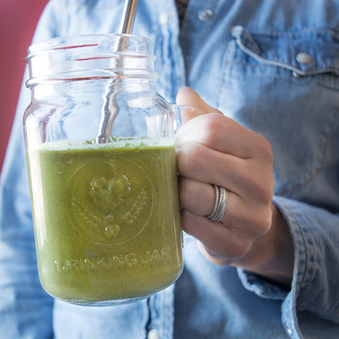 Green smoothie with sliced kiwi, banana, and pumpkin seed butter. Perfect on-the-go breakfast. 