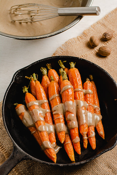 Roasted carrots with maple sunflower seed butter glaze. Makes a great appetizer for dinner or parties.